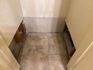 Small bathroom or entryway with gray tile flooring and white walls