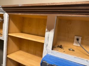 Open wooden cabinet with two shelves and white painted frame