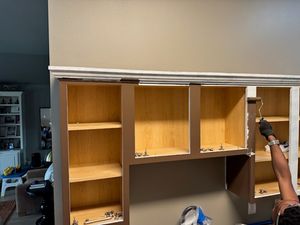 Wooden cabinet shelving unit with glass doors and open compartments in office space