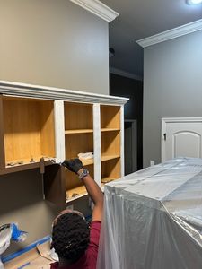 Person installing wooden shelving units in bedroom under construction
